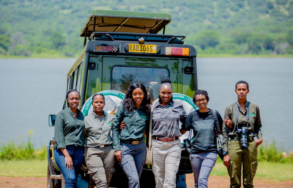 Judith Uwimana (third from right), the founder and CEO of Judith Safaris and her team posing for a group photo in Akagera National Park, Rwanda.